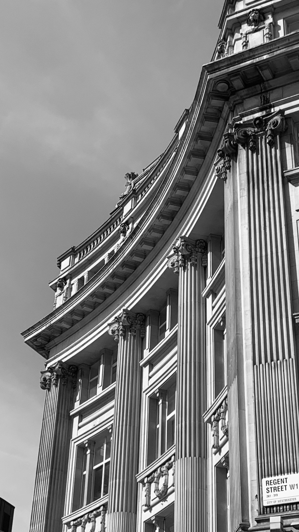Black and white photograph of a curved architectural facade on Regent Street