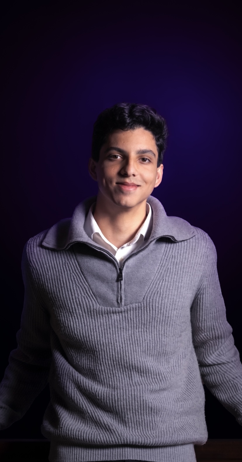 Portrait of Filipe Rodrigues against a dark violet background